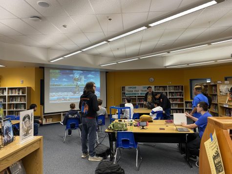Sophomores Josef Gavagan and Joel Pentasa, along with other Game Club Marathon attendees look on as students participate in a Smash Bros. Ultimate tournament.