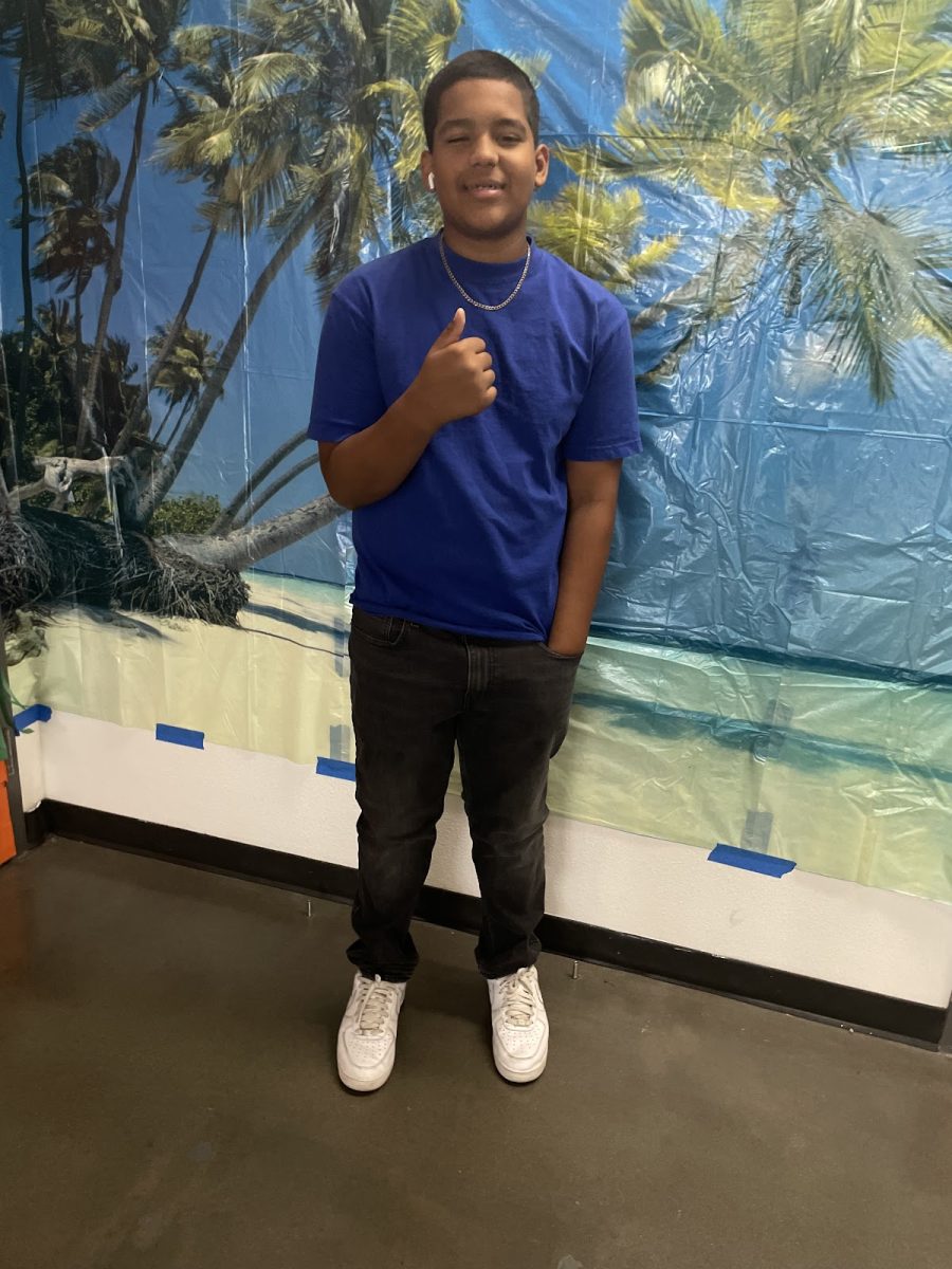Freshman Class President Jace Stewart poses with Spirit Day Hawaiian Set Up 
